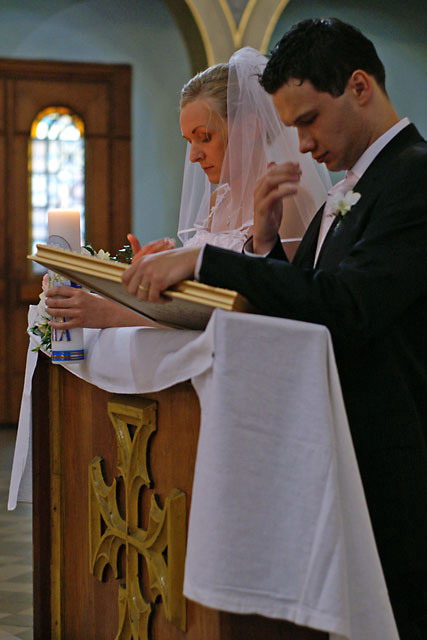 Para młoda modląca się podczas ceremonii ślubnej